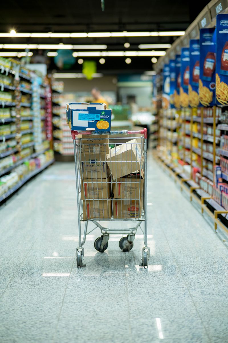 A family planning their weekly grocery budget together at a kitchen table with a shared shopping list.